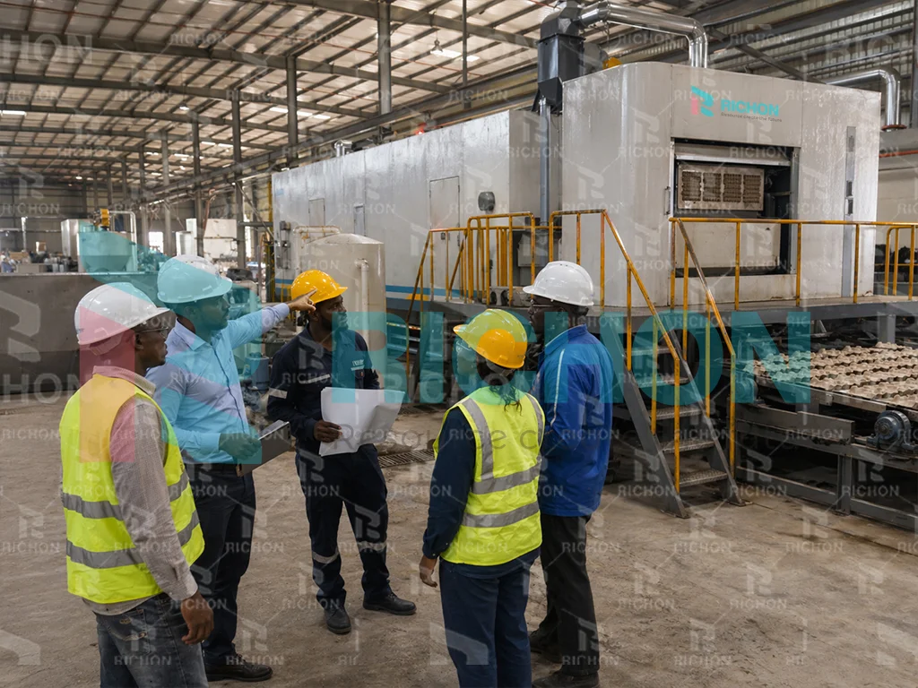 engineering team reviewing cameroon egg tray factory project implementation and production planning