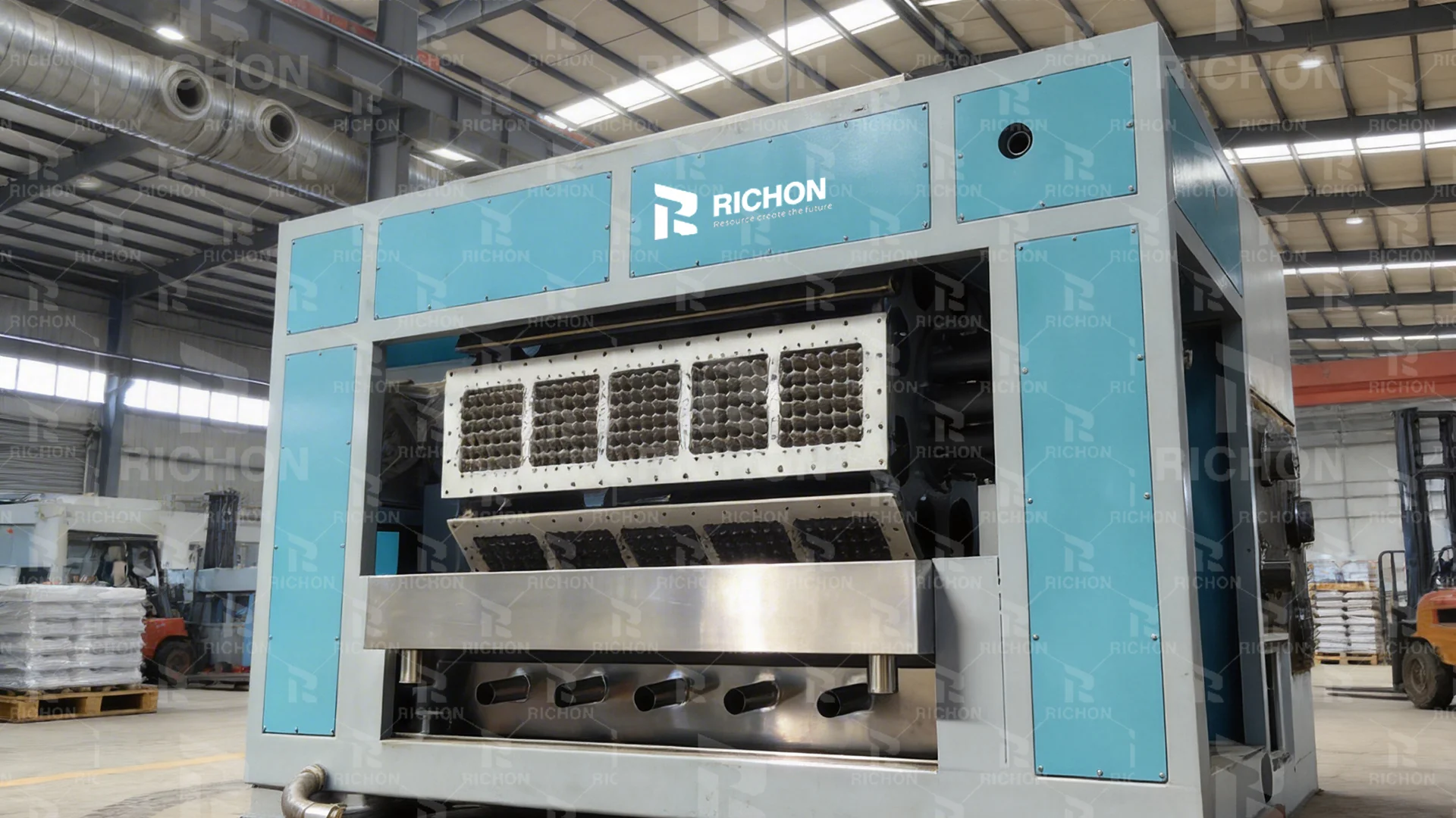 Richon-watermarked close view of egg tray forming equipment and mold assemblies in a workshop