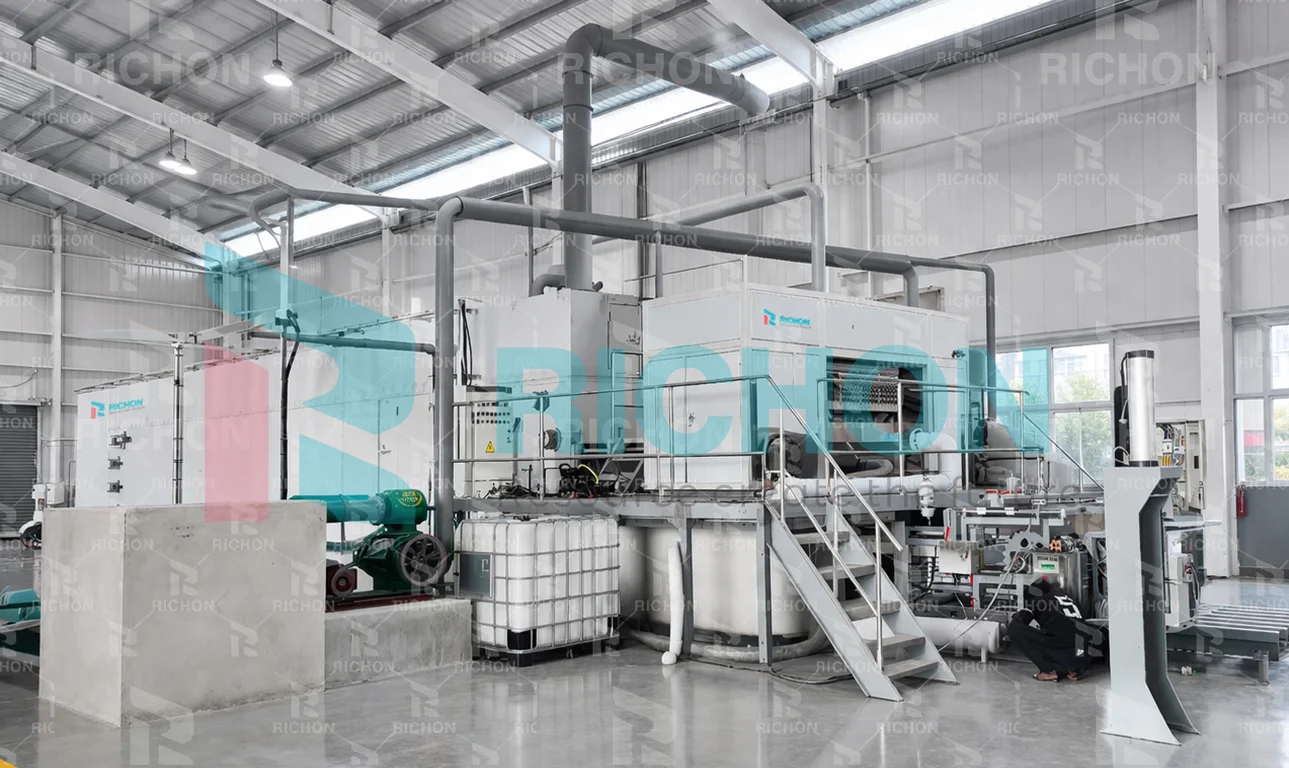Richon equipment installation inside a workshop, with service pipes and access stairs